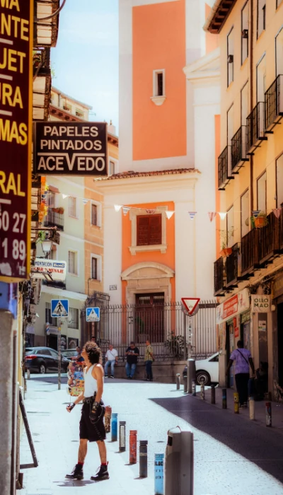 Woman walking down a street in Spain